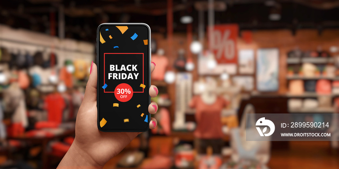 Black friday sale advert on mobile phone. The concept of shopping online. Shop with discounts in background