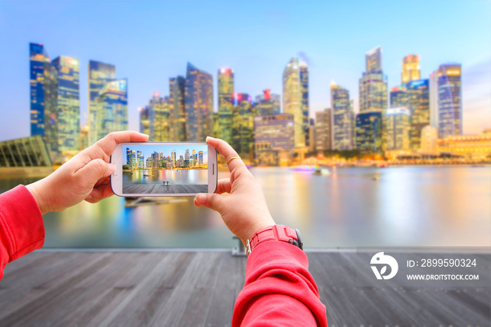 Smartphone photographing landscape of the Singapore financial district and business building