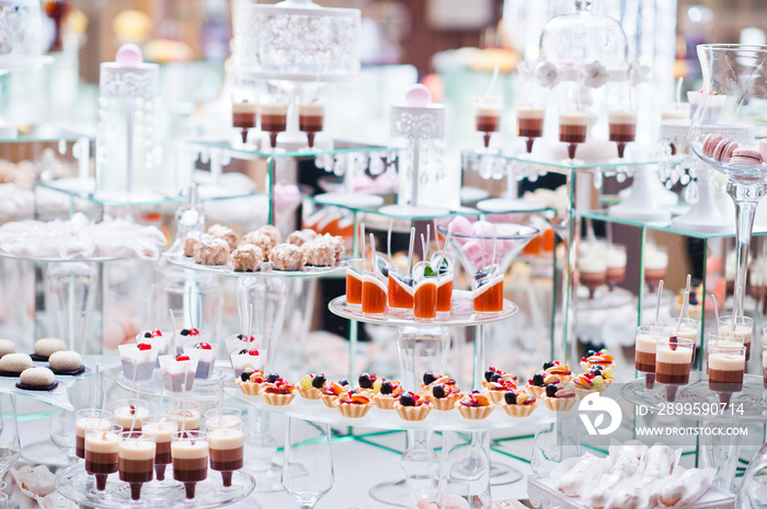 Dessert table of delicious sweets on wedding reception.