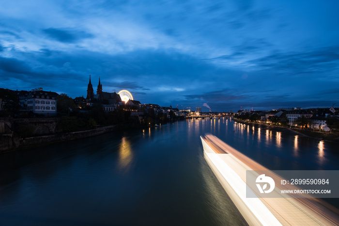 Basel Switzerland at night over the Rhine river.