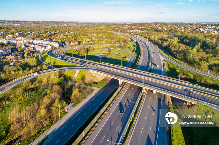 Motorway junction on A4 beltline around Krakow, Poland.  Overpass crossroad with slip roads, viaducts and traffic. Aerial view