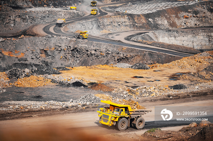 Big yellow mining truck transportation of gold ore. Open pit mine industry