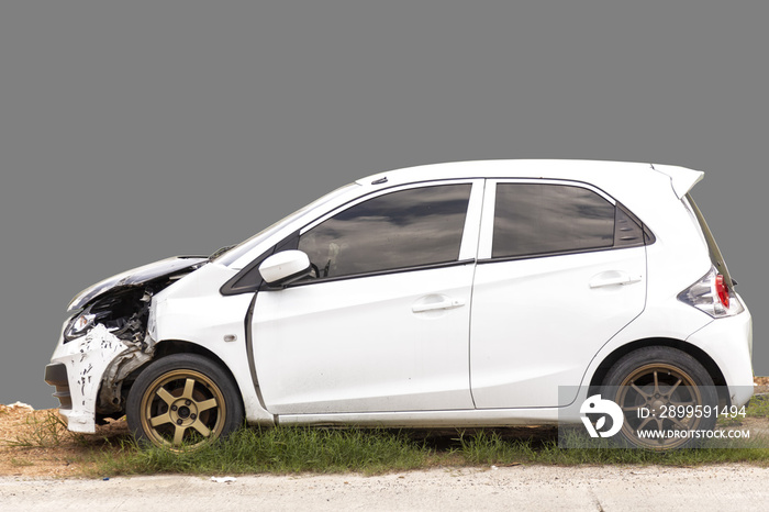 Front of white color car damaged and broken by accident park on road. Gray background with clipping path car and road