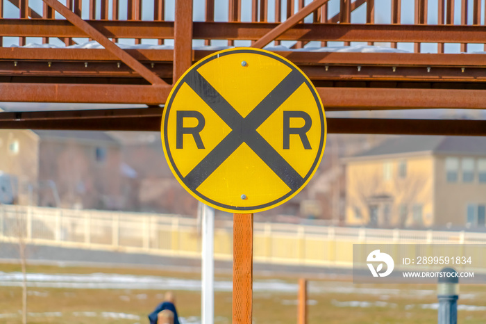 Railway sign with a snowy bridge in the background