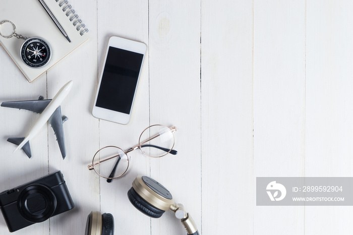 Travel accessories on white wooden copy space