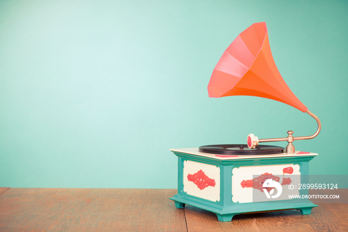 Retro old gramophone front mint green background