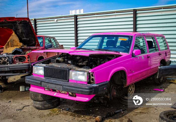 The remains of crashed pink Volvo