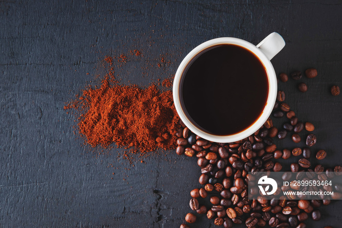 Hot coffee with coffee powder and coffee beans on a black background