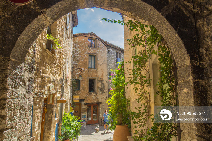 Looking through an arch at a quaint side street in Tourrettes-sur-Loup, France