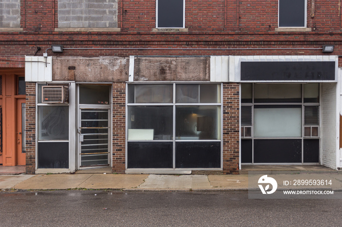 Multiple empty storefronts on old street in a forgotten neighborhood