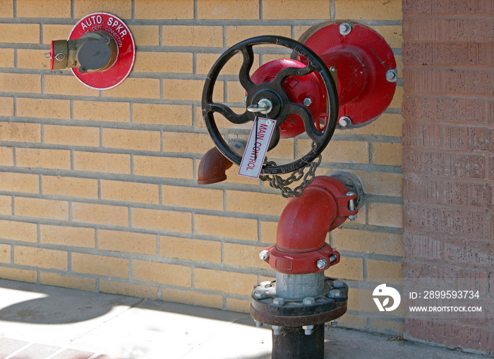 Close-up view on an installation of fire sprinkler valves and hydrant outlets on a wall