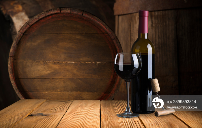 red wine bottle and wine glass on wodden barrel