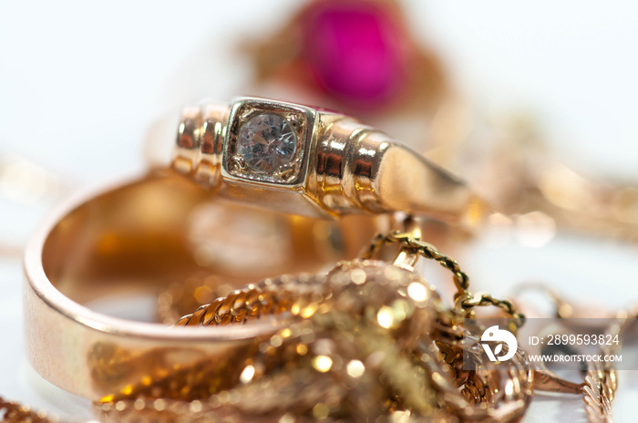 Gold jewelry  with gems , chains close up macro shot isolated on white background.