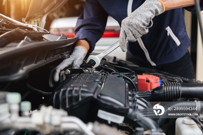 Automobile mechanic repairman hands repairing a car engine automotive workshop with a wrench, car service and maintenance,Repair service.