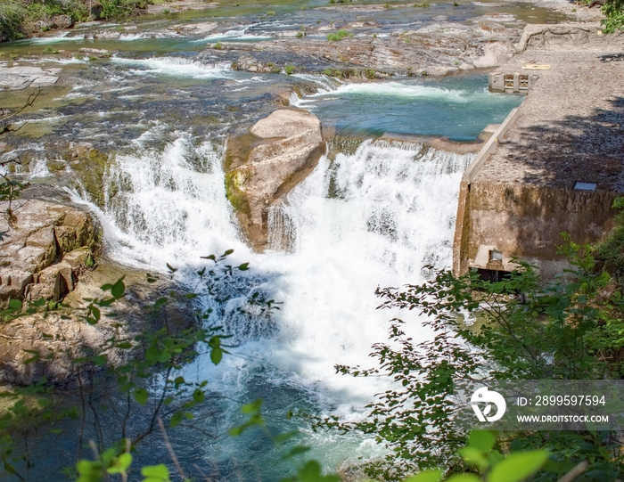 Majestic Steamboat Falls and the Fish Ladders of the North Umpqua National Forest gushing from a blue drainage in the mountains of Douglas County southern Oregon in the springtime