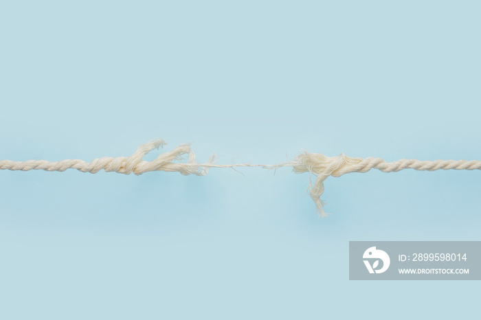 Frayed rope on color background