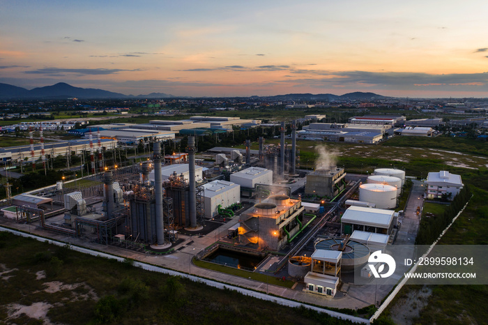 Aerial view night light oil terminal is industrial facility for storage of oil and petrochemical. oil manufacturing products ready for transport and business transportation. power electric plant.