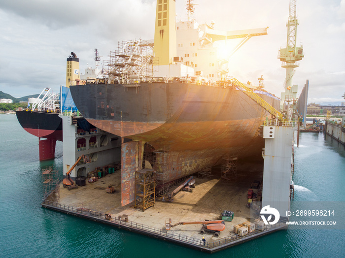 Cargo container ship stern with propeller at dry dock for maintenance follow annual plan and service.