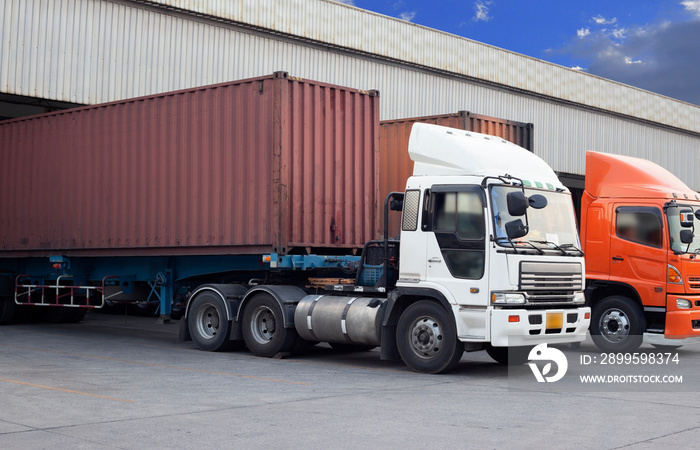 Cargo Container Trucks Parked Loading Dock at Distribution Warehouse. Shipping Trucks. Lorry. Cargo Freight Trucks Transport Logistics.