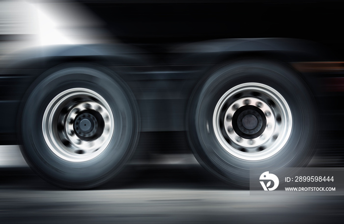 Speeding Motion Blur of Semi Truck Spininng Wheels. Truck Driving on The Road. Industry Freight Truck Transport.