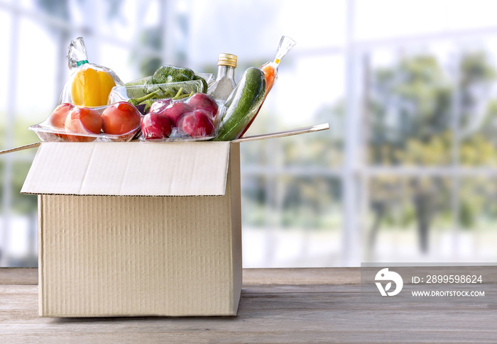 Food Delivery service: Vegetable delivery at home online order for cooking and packages box with blank for text. on wooden table background.(with clipping path)