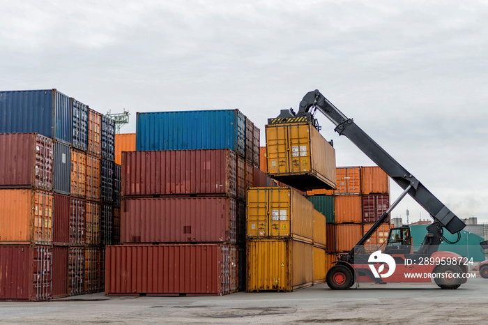 Mobile stacker handler in action at a container terminal.