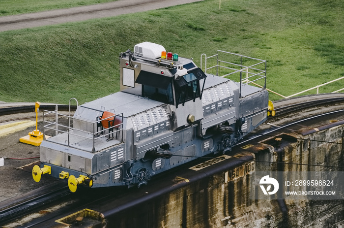 locomotives, known as mules, pull ships in the Panama Canal