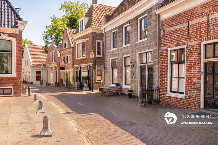 Narrow street with old houses in the picturesque town of Appingedam in the province of Groningen; Netherlands.