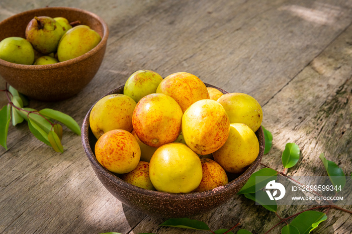 Mangaba fruit from the northeast of Brazil on an aged wooden table.