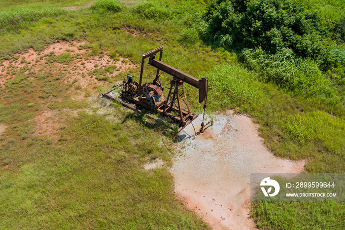 Low view of a working oil pump jack pumping crude in Oklahoma USA