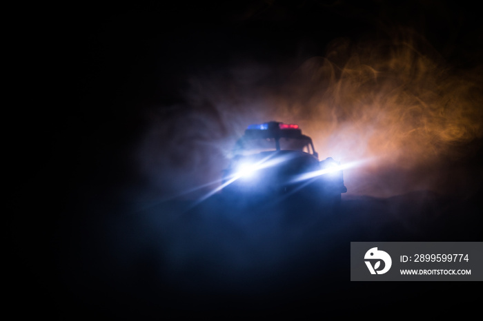 Police cars at night. Police car chasing a car at night with fog background. 911 Emergency response