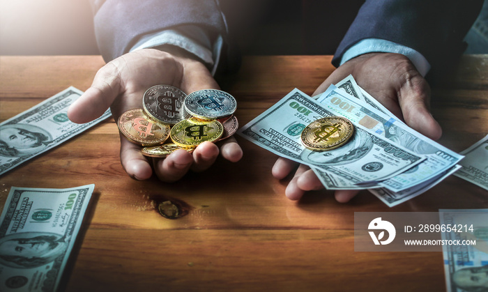 Close up businessman holding money and bitcoin on wooden desk