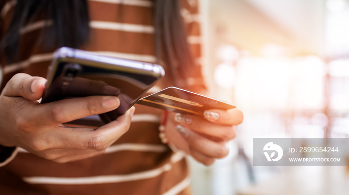 Close up young woman hands holding credit card.