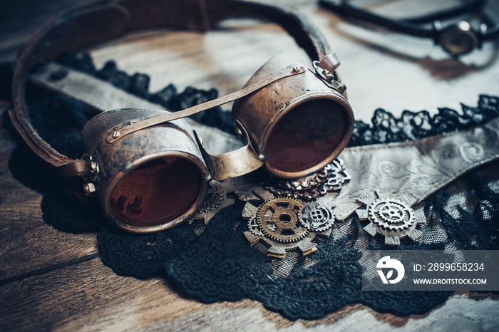 A beautiful still-life in the steampunk style with protective goggles and accessories of womens clo