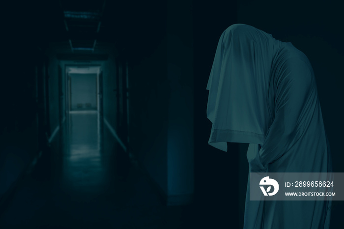 The man is in white clothes and shows a scary looking face  at a creepy hotel corridor, look like gh