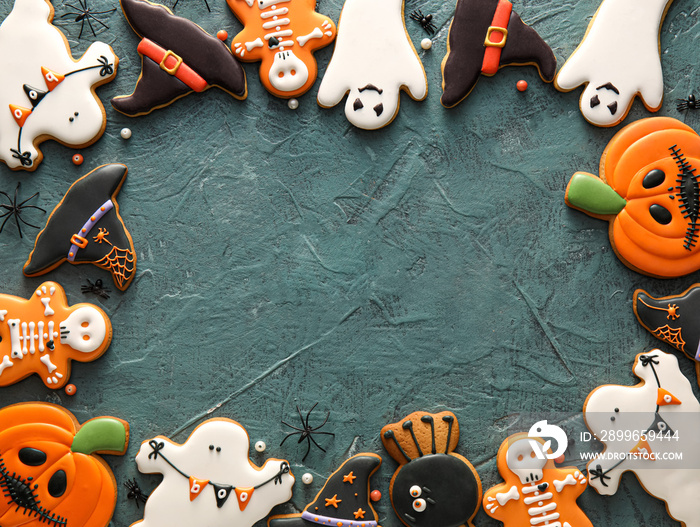 Frame made of tasty cookies for Halloween celebration on dark background