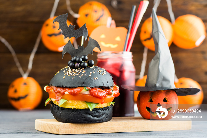 Halloween Spooky Black Burger with Cheese. Cheeseburger on Halloween pumpkin head jack lantern backg