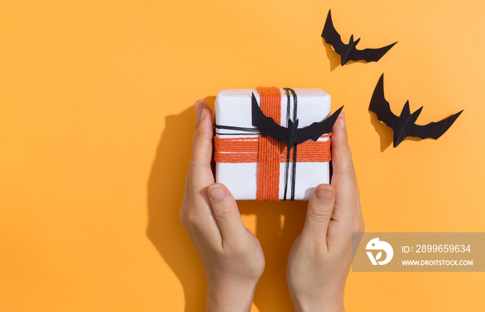 Halloween theme with gift box on a orange background