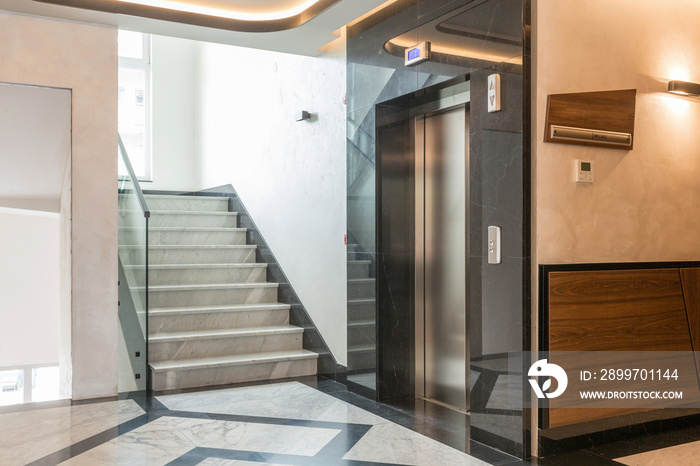 Interior of a shiny marble hotel corridor with elevator