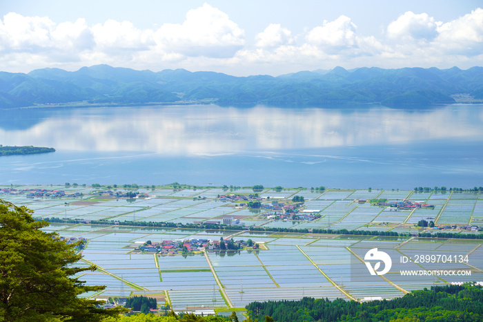 福島県・磐梯山から見下ろす田植え後の、猪苗代の町と猪苗代湖