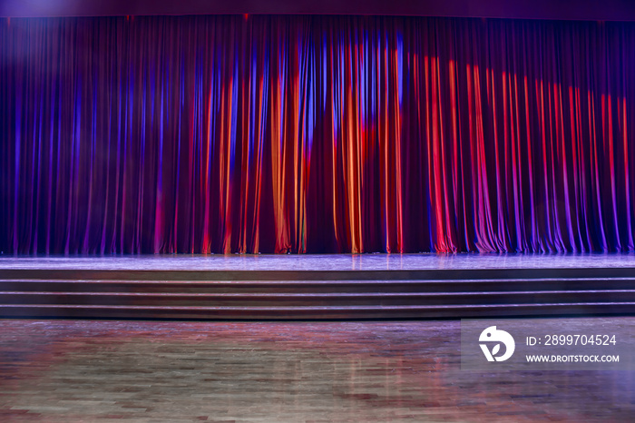 Red curtains and wooden stage.