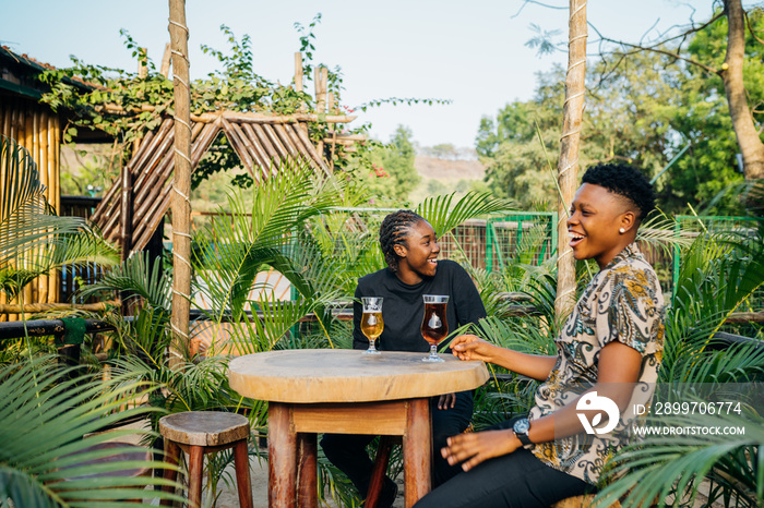 Two queer masculine black women in a garden