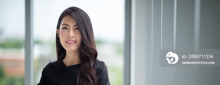 Headshot young lady standing in office