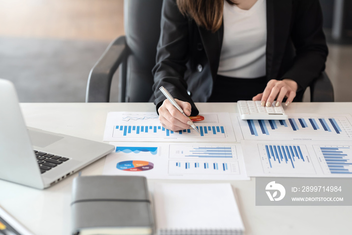 Close up Businesswoman working  analysis pointing graph at the office.