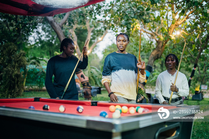 Queer masculine women playing pool