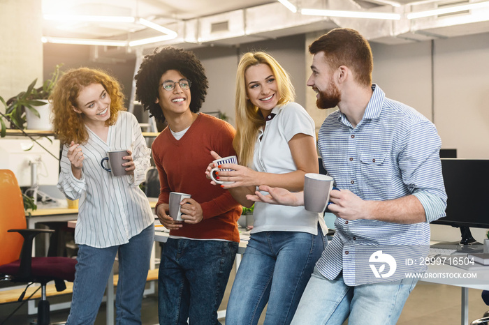 Business team drinking coffee while having free time in office