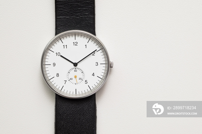 Minimalist wristwatch white dial on white background