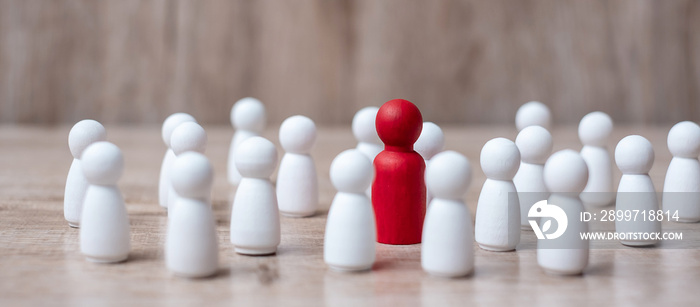 red leader businessman with crowd of wooden employees. leadership, business, team, teamwork and Huma