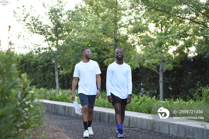 USA, Louisiana, Gay couple in sports clothing walking in park