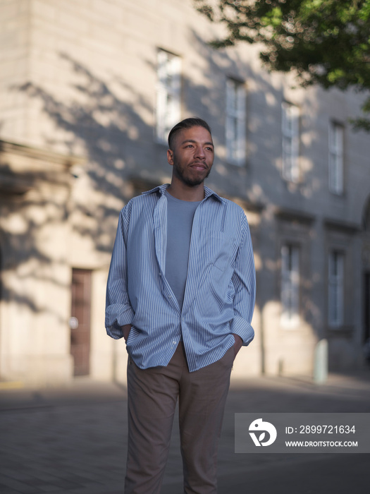 UK, South Yorkshire, Portrait of pensive man in white shirt standing outdoors